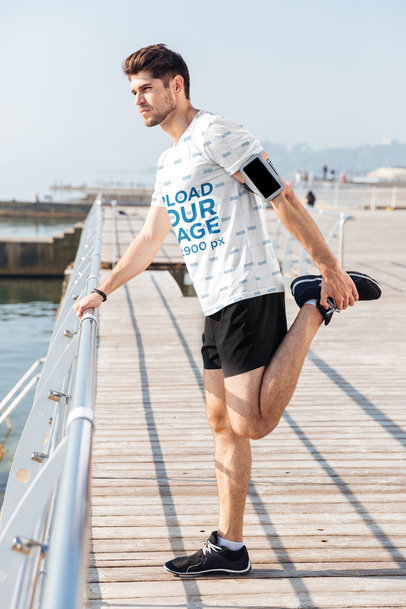 Sublimated T-Shirt Mockup of a Man Stretching His Leg Before a Jog