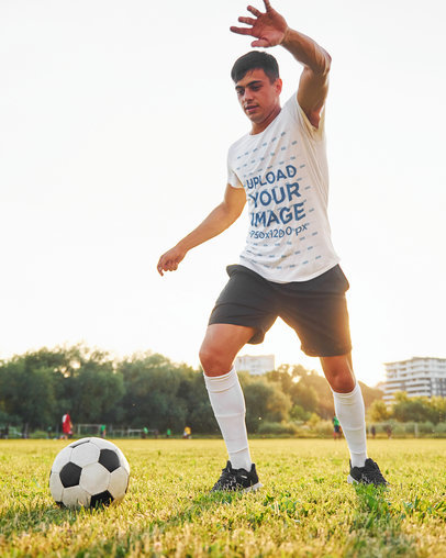 T-Shirt Mockup Featuring a Man Playing Soccer on a Field