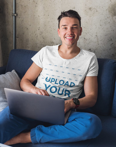 T-Shirt Mockup of a Happy Young Man Working From Home