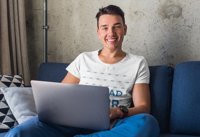 Mockup of a Young Man Working From Home While Wearing a Heather Tee