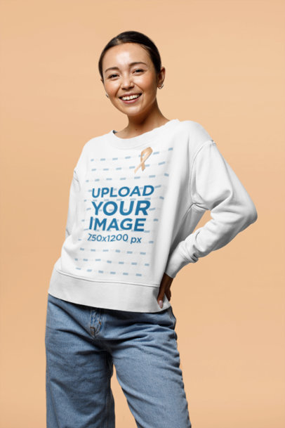 Sweatshirt Mockup of a Smiling Woman Wearing a Ribbon for Cancer Awareness