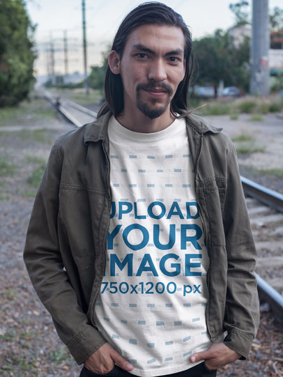 Smiling Man with Long Hair and Beard Wearing a T-Shirt Mockup on Train Rails