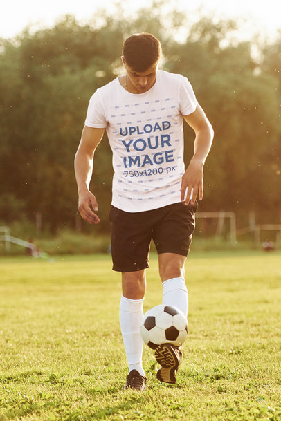 Round-Neck T-Shirt Mockup of a Sporty Man Playing Soccer