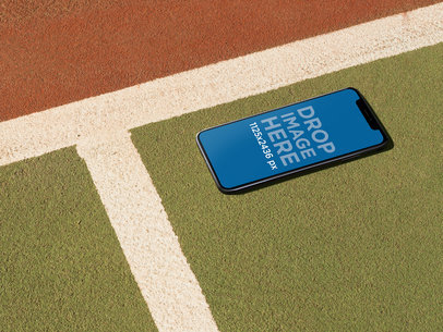 Mockup of an iPhone 11 Pro Lying on a Tennis Court