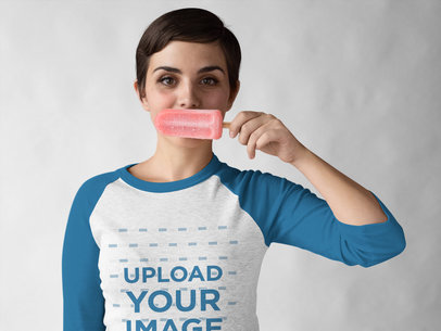Woman Wearing a Heathered Raglan Tee Mockup while Holding a Popsicle Against her Mouth