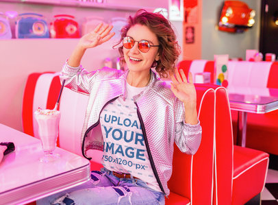Basic Tee Mockup Featuring a Happy Woman at a Retro Diner