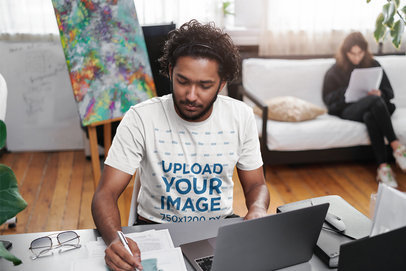 T-Shirt Mockup of a Creative Young Man Working at a Desk m11954-r-el2