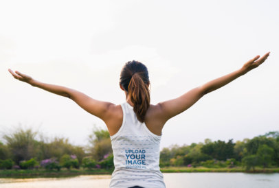 Mockup of a Woman in a Racerback Tank Top with Her Arms Wide Open