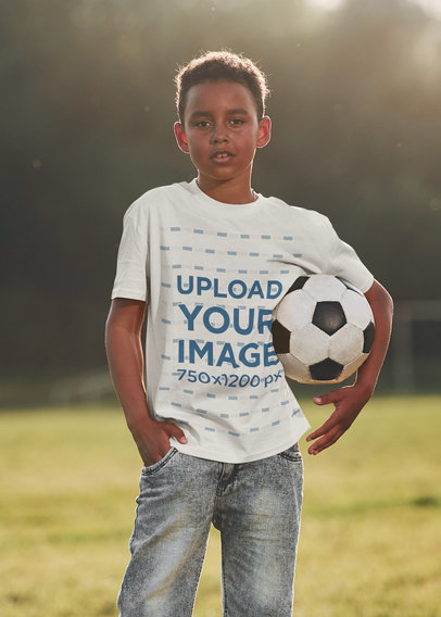 T-Shirt Mockup Featuring a Serious Boy With a Soccer Ball