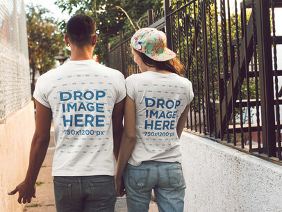 Couple Walking in a Hall Wearing Round Neck Tees Mockup from the Back