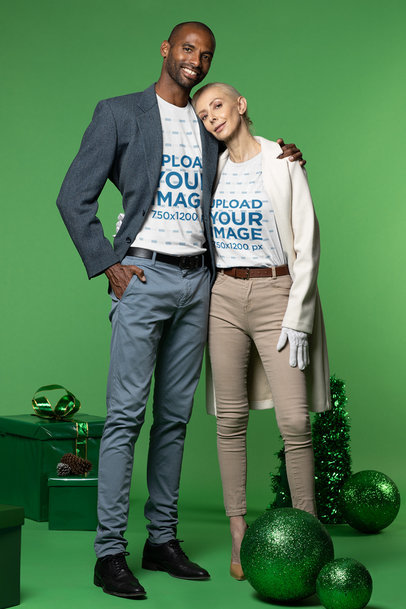 T-Shirt Mockup of a Man and a Woman Hugging at a Xmas-Decorated Studio