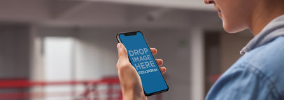 Young Man Using an iPhone 11 Pro Mockup at School