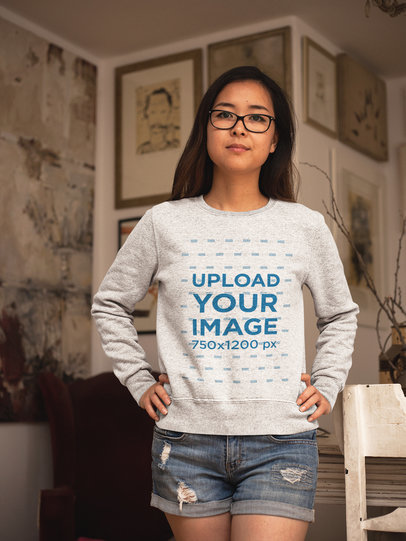 Asian Girl Wearing a Crew Neck Sweatshirt Template While Inside a Room with Paintings a17607
