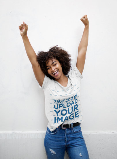Heather T-Shirt Mockup Featuring a Happy Woman With Her Arms Raised 