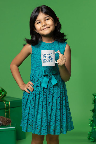 Mockup of a Little Girl Holding an 11 oz Coffee Mug in a Christmas-Themed Set