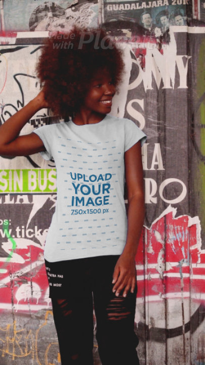 T-Shirt Video of a Happy Young Woman Posing In an Urban Scenario
