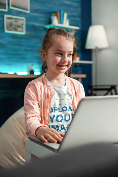 T-Shirt Mockup of a Smiling Girl Using a Laptop in Her Bedroom m17107-r-el2