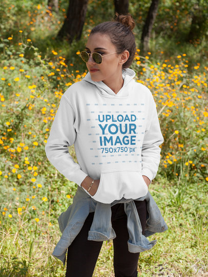 Girl Wearing a Hoodie Mockup While Standing Near Flowers Outdoors a17673