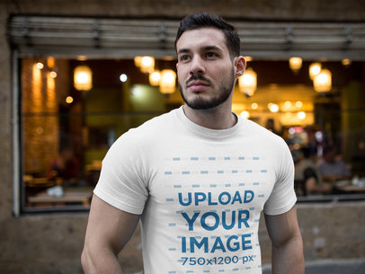 Buff Dude Wearing a Tshirt Mockup while Near a Cafe
