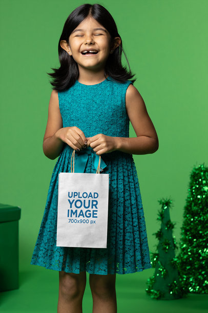 Gift Bag Mockup Featuring a Happy Little Girl During Christmas Eve