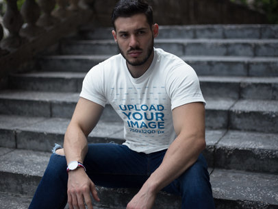 Strong Dude Wearing a T-Shirt Mockup While Sitting on Stairs