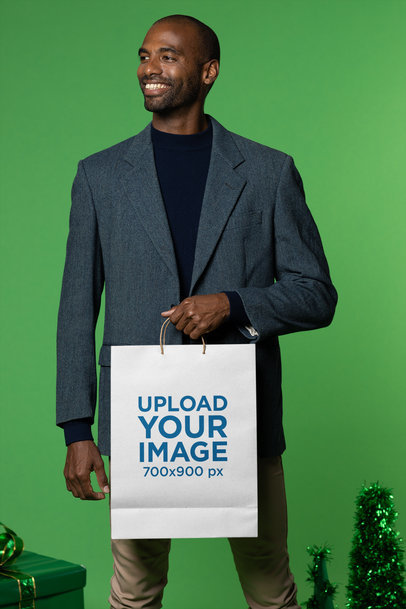 Gift Bag Mockup Featuring a Smiling Man in a Christmas-Decorated Studio m17991