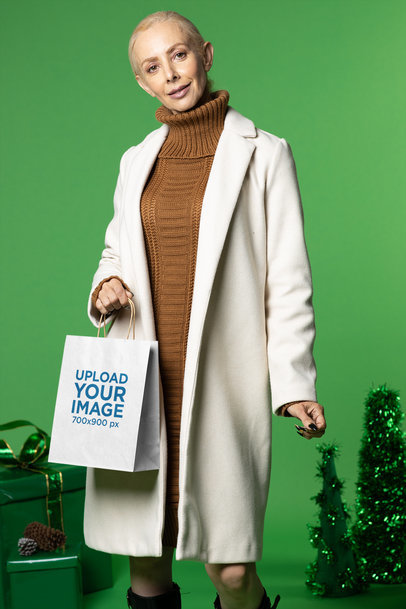 Xmas-Themed Mockup Featuring a Happy Senior Woman Holding a Gift Bag