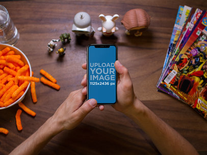 Man Gaming with iPhone 11 Pro Mockup While on his Table
