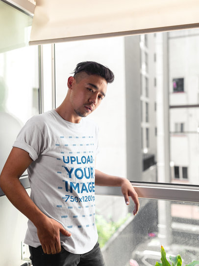 Man Wearing a T-Shirt Template While Against the Hotel Room Window