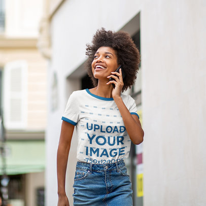 Ringer T-Shirt Mockup of a Curly-Hair Woman Smiling and Talking on the Phone
