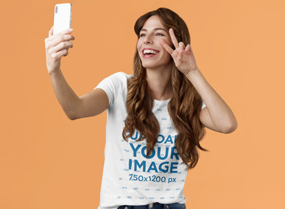 T-Shirt Mockup of a Happy Long-Haired Woman Taking a Selfie