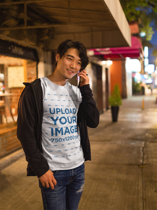 Happy Asian Man Talking on the Phone Wearing a T-Shirt Mockup