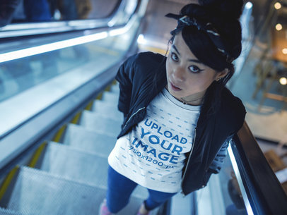 Beautiful Girl Wearing a Tshirt Mockup while Using Electric Stairways a17814