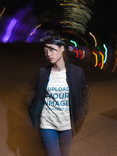 Trendy Woman Wearing a T-Shirt Mockup While Walking on the Street at Night
