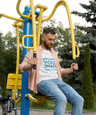 T-Shirt Mockup of a Serious Doing Arm Exercises at a Park 