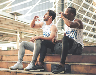 Sleeveless Tee Mockup of Two Friends Drinking Water
