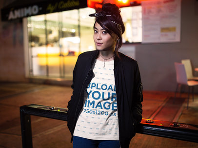 Woman Wearing a Round Neck Tshirt Template While Outside a Restaurant at Night