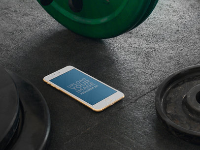 Mockup of a Gold iPhone 6 on a Gym Floor