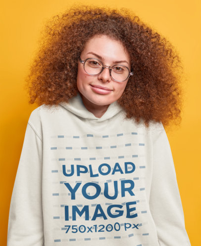 Hoodie Mockup of a Curly-Haired Woman With Glasses in a Studio