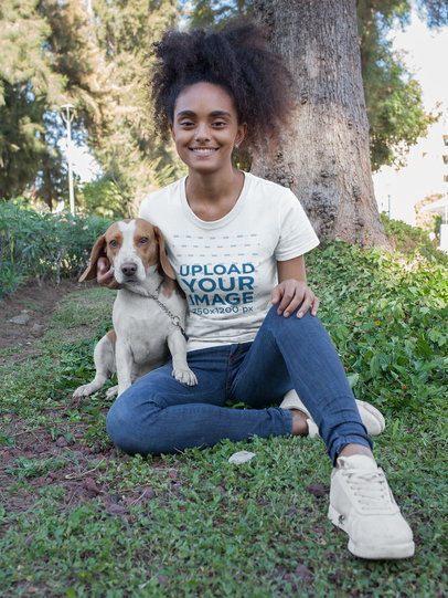 Smiling Woman Wearing a T-Shirt Mockup while with her Dog at the Park