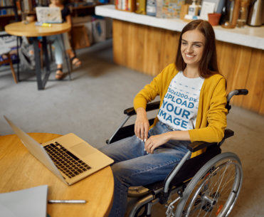 T-Shirt Mockup of a Woman Using a Wheelchair and Working
