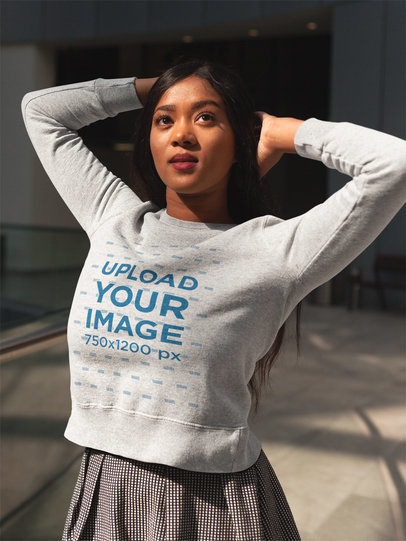 Woman Wearing a Crewneck Sweatshirt Template While Posing for the Picture