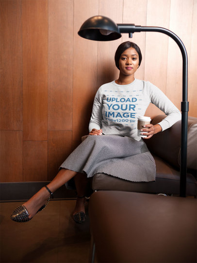 Mockup of a Woman Wearing a Crew Neck Sweatshirt While Sitting on a Sofa 17751