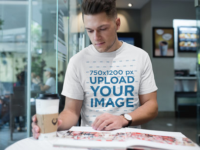 Man Wearing a Round Neck Tee Mockup While Reading a Magazine