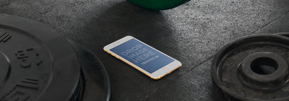 Wide Mockup of a Gold iPhone 6 on a Gym Floor