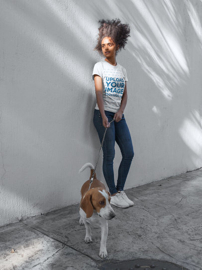 Curly Haired Girl Wearing a Tshirt Mockup While Walking Her Dog a17843