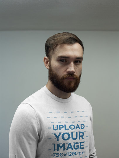 Serious Man Wearing a Crewneck Sweatshirt Template While Standing Inside a Room