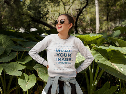 Smiling Girl Wearing a Crew Neck Sweatshirt Template Near Plants a17670