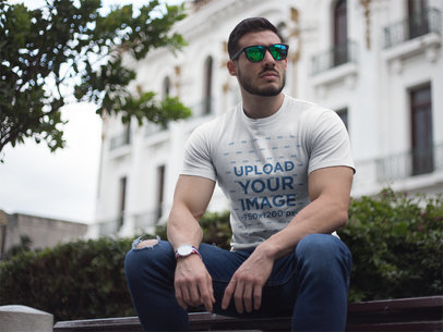 Buff Guy Wearing a Tshirt Mockup While Sitting 