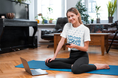Mockup of a Woman Getting Ready for an Online Yoga Class While Wearing a Knotted Tee 